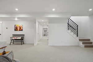 Finished below grade area with light carpet and recessed lighting