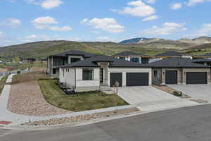 Prairie-style house featuring a mountain view, an attached garage, and concrete driveway
