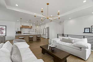 Living room featuring hanging lights and light wood-type flooring