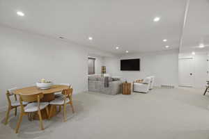 Dining room featuring light carpet and recessed lighting