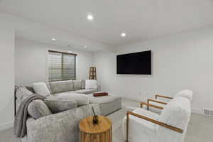Living area featuring carpet floors and recessed lighting