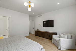 Bedroom with light wood-type flooring and recessed lighting