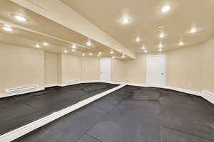 Workout room with recessed lighting, a baseboard heating unit, and baseboard heating