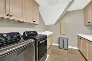 Laundry area featuring cabinet space and washing machine and dryer