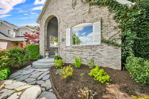 Entrance to property featuring brick siding
