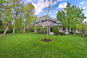 View of front facade featuring a front lawn and brick siding