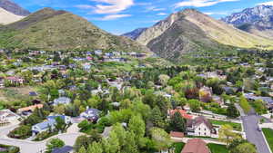 Aerial perspective of suburban area featuring a mountain backdrop