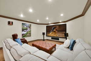 Cinema room with recessed lighting, ornamental molding, and carpet flooring