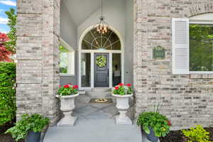 View of exterior entry featuring stucco siding