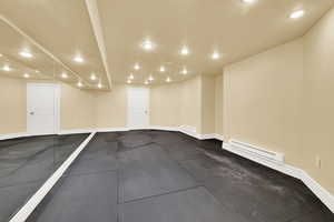 Garage featuring recessed lighting and a baseboard heating unit