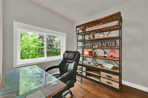Office featuring dark wood-style flooring and baseboards
