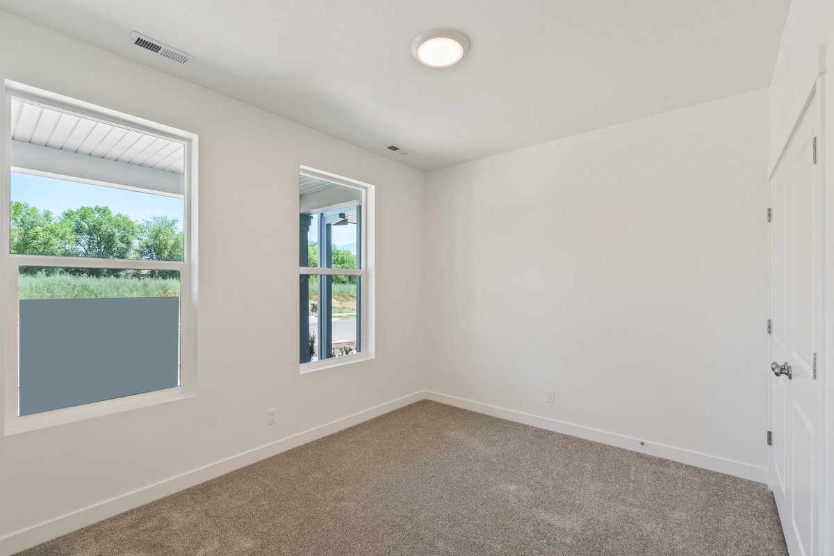 Unfurnished room featuring baseboards and dark carpet