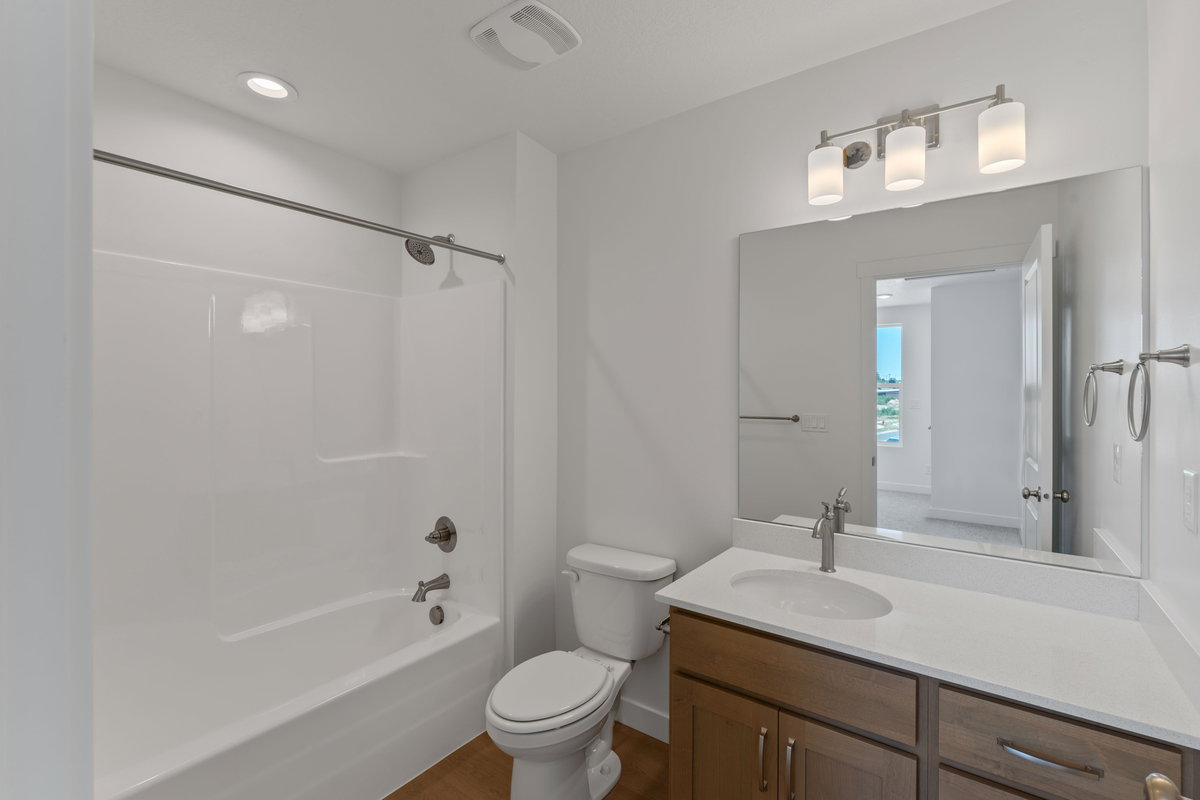 Full bath with vanity, tub / shower combination, dark wood-type flooring, and recessed lighting