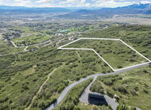 View of property location with property parcel outlined and a water and mountain view