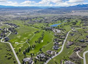 Bird's eye view of a local golf course and a water and mountain view