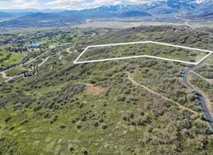 Aerial view of property's location featuring property parcel outlined and a water and mountain view