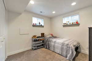 Bedroom with carpet floors, recessed lighting, and a closet