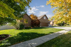 Traditional-style home featuring brick siding and concrete driveway
