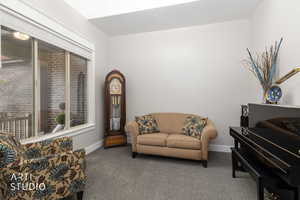 Living area featuring carpet and baseboards