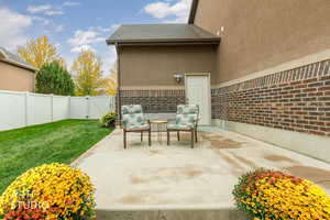 Fenced backyard with a gate and a patio