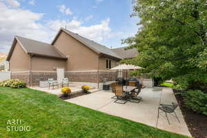 View of patio featuring outdoor dining area and a grill