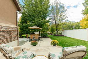 Fenced backyard with outdoor dining space and a patio area