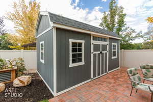 View of shed with a fenced backyard