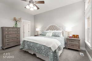 Bedroom featuring dark colored carpet and ceiling fan