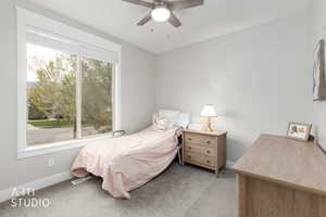 Bedroom featuring light colored carpet and ceiling fan