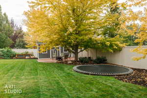 Fenced backyard featuring a patio and a trampoline