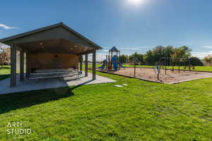 Community play area with a lawn and a patio