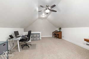 Home office featuring light carpet and a ceiling fan