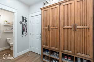 Mudroom with light wood-style flooring and baseboards