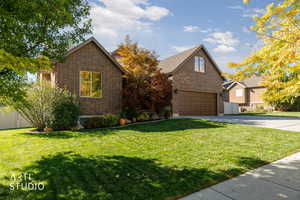Traditional home featuring brick siding and concrete driveway