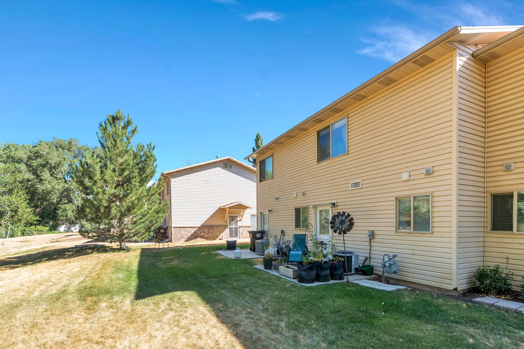 Rear view of house featuring a lawn and a patio area