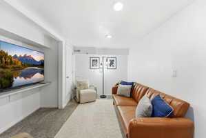 Living room with light colored carpet and baseboards