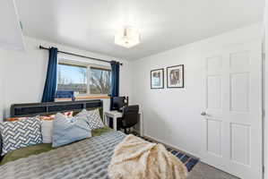 Bedroom featuring carpet flooring and baseboards