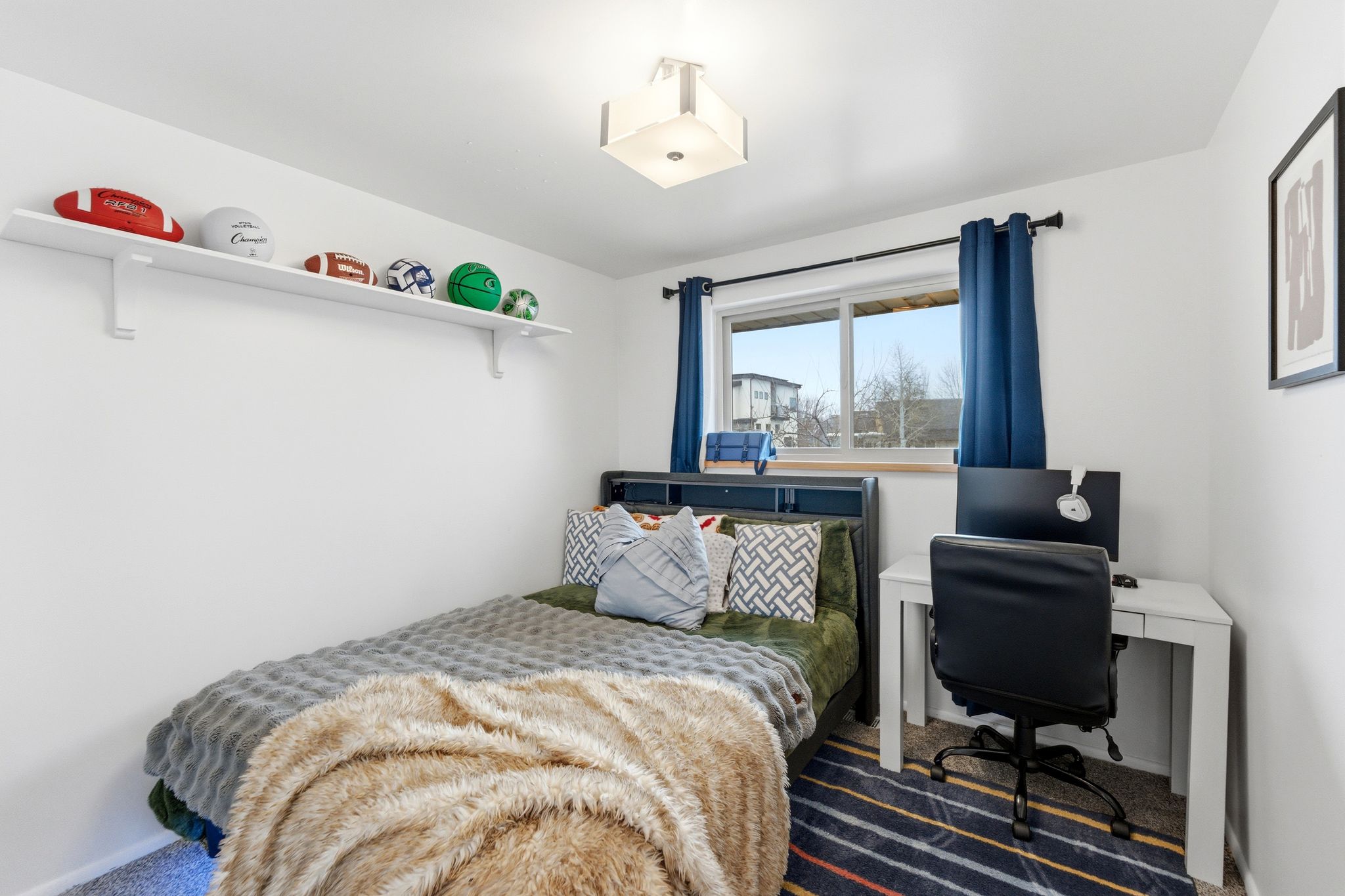 Carpeted bedroom featuring a desk