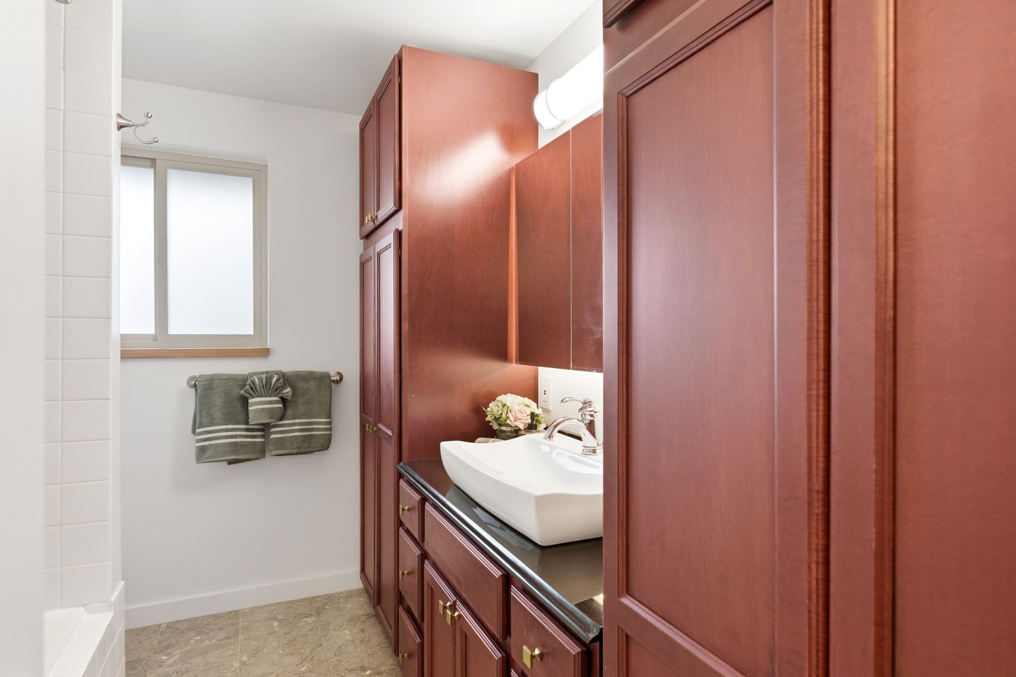 Full bath featuring vanity and baseboards