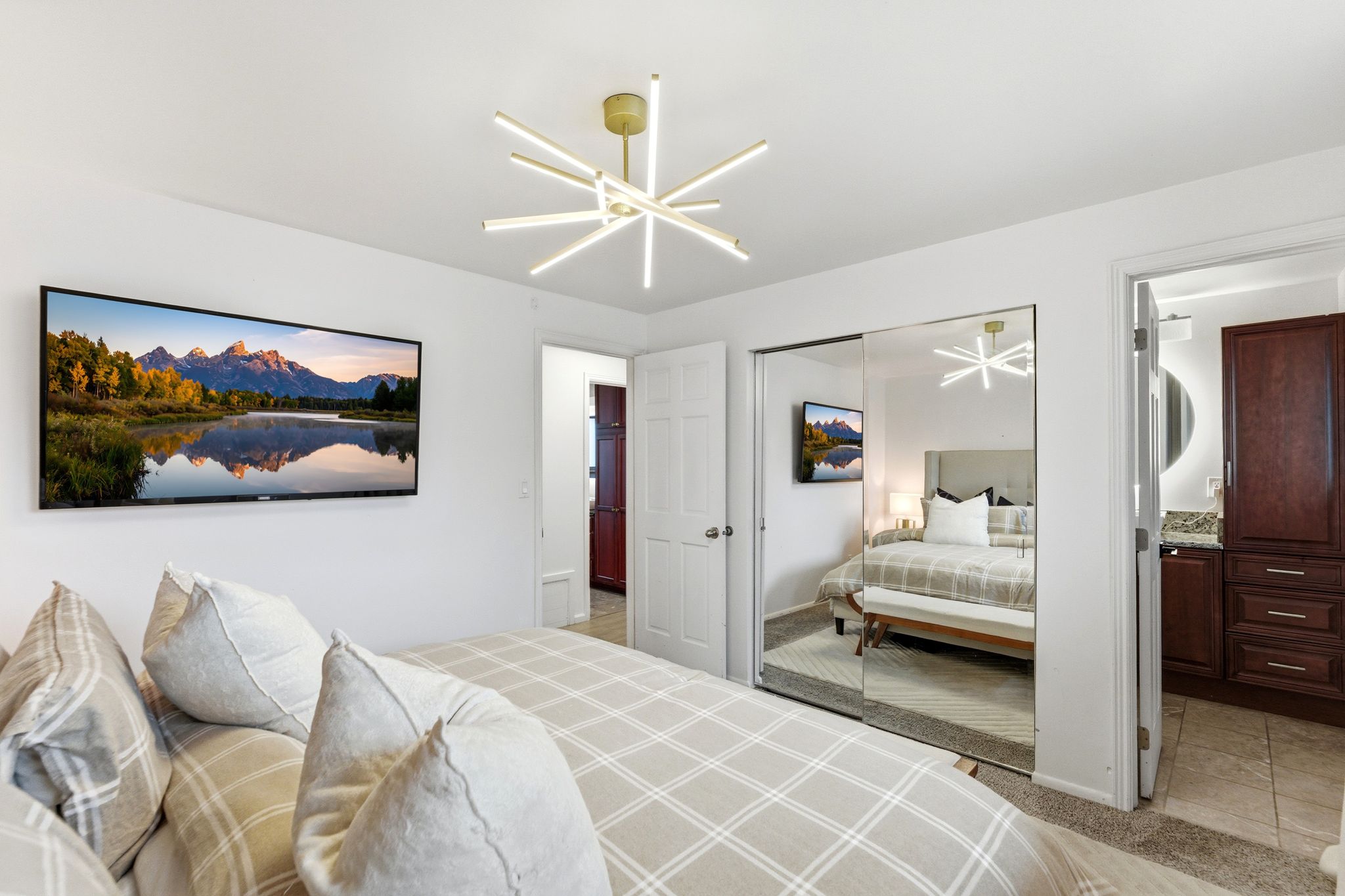 Bedroom with light colored carpet and a closet