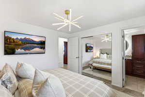 Bedroom with light colored carpet and a closet