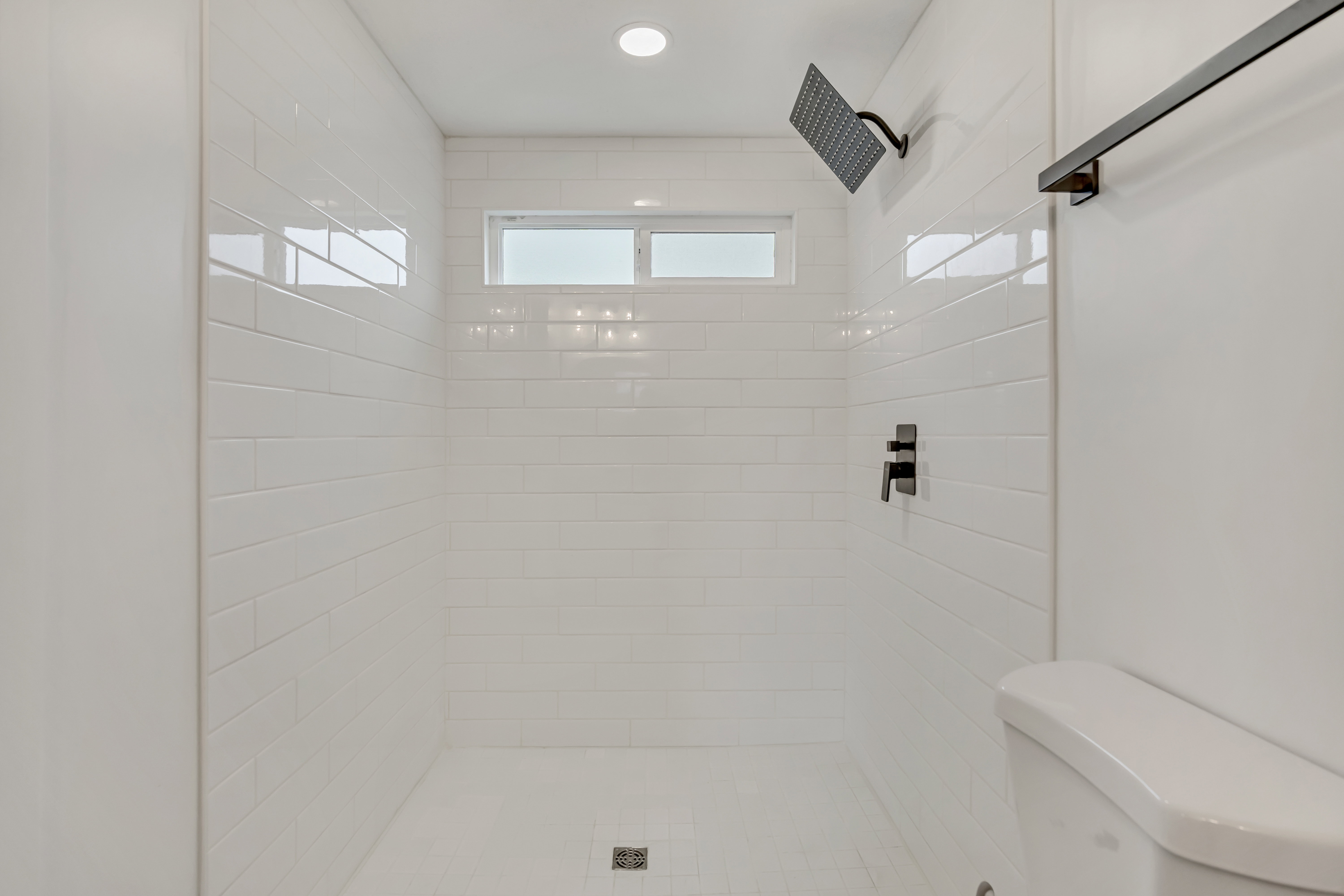 Full bathroom with toilet and a stall shower