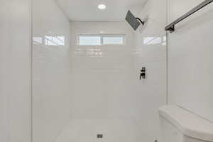 Full bathroom with toilet and a stall shower