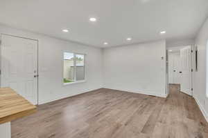 Unfurnished living room with recessed lighting and light wood-type flooring