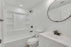 Bathroom with vanity, shower / bathtub combination, and recessed lighting