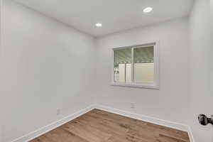 Empty room featuring light wood-type flooring and recessed lighting