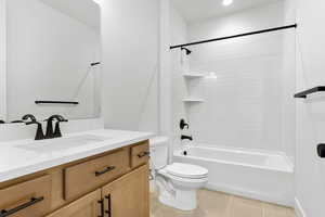 Bathroom featuring vanity, light tile patterned flooring, tub / shower combination, and recessed lighting