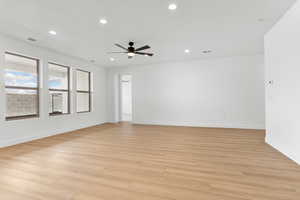 Spare room featuring a ceiling fan, light wood-type flooring, and recessed lighting
