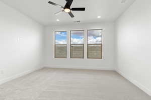 Unfurnished room with light colored carpet, a ceiling fan, and recessed lighting