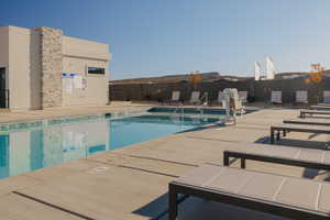 Community pool with a patio